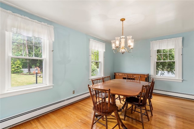 dining room featuring a baseboard radiator, a chandelier, and light wood-style floors