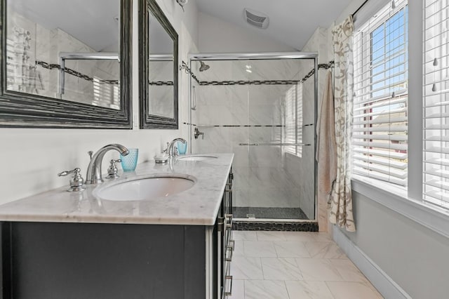 224 Gibbs Ave, Newport, RI 02840 - bathroom with lofted ceiling, a stall shower, marble look tile flooring, double vanity, and baseboards