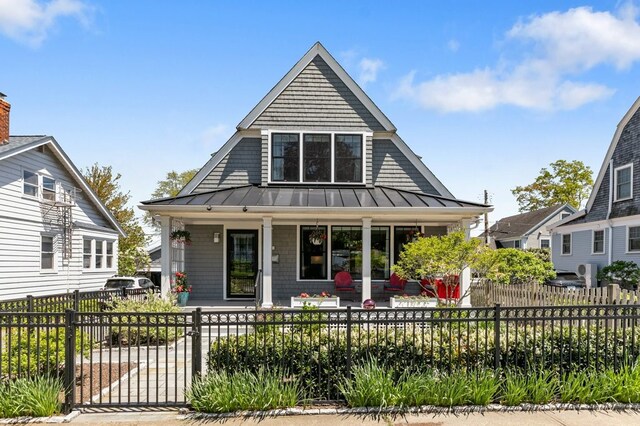 224 Gibbs Ave, Newport, RI 02840 - view of front facade featuring covered porch, a standing seam roof, metal roof, and a fenced front yard