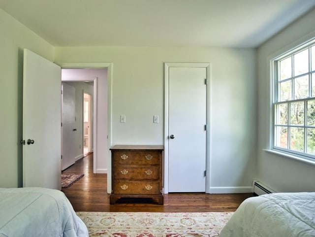 58 Leonard Dr, Tiverton, RI 02878 - bedroom featuring multiple windows, wood finished floors, baseboards, and a baseboard radiator