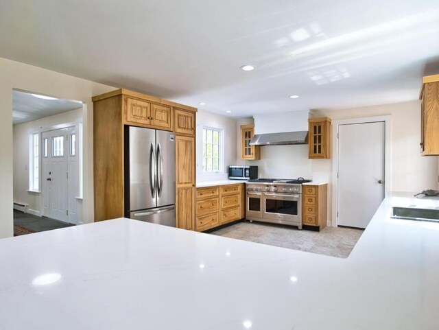 58 Leonard Dr, Tiverton, RI 02878 - kitchen with appliances with stainless steel finishes, wall chimney range hood, light countertops, a baseboard heating unit, and recessed lighting