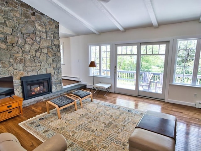 58 Leonard Dr, Tiverton, RI 02878 - living room featuring baseboard heating, plenty of natural light, wood finished floors, and a stone fireplace