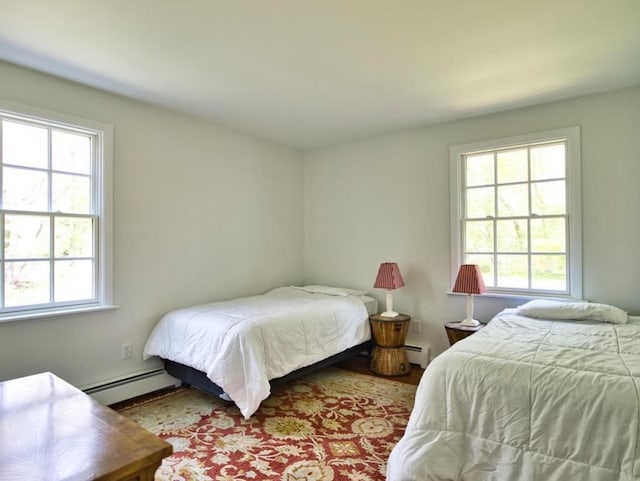 58 Leonard Dr, Tiverton, RI 02878 - bedroom featuring a baseboard radiator, multiple windows, and wood finished floors