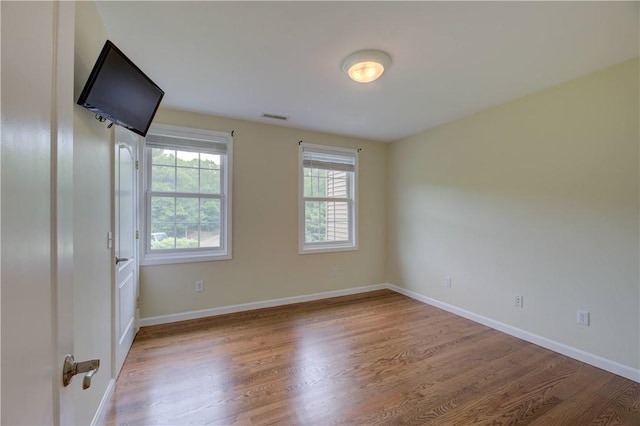 34 Ledgefield Rd, Scituate, RI 02857 - spare room featuring plenty of natural light, wood finished floors, and baseboards