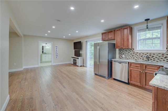 34 Ledgefield Rd, Scituate, RI 02857 - kitchen featuring appliances with stainless steel finishes, brown cabinets, backsplash, light wood-type flooring, and recessed lighting
