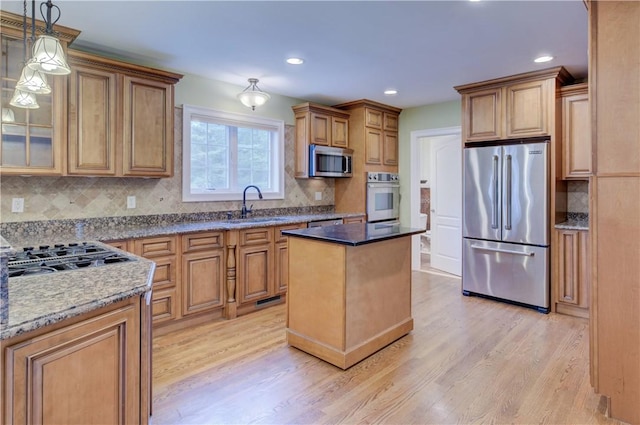 34 Ledgefield Rd, Scituate, RI 02857 - kitchen featuring stainless steel appliances, a sink, light wood finished floors, backsplash, and recessed lighting