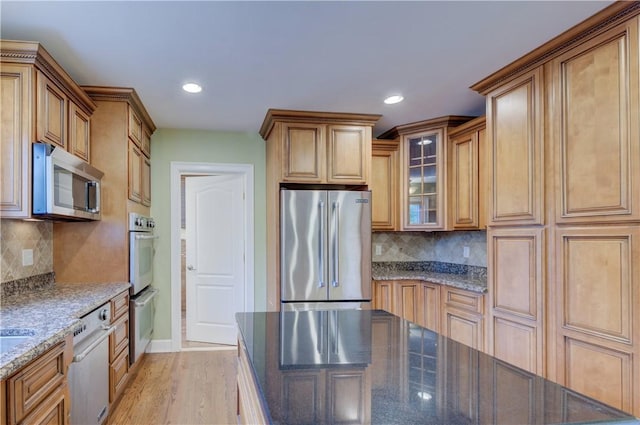 34 Ledgefield Rd, Scituate, RI 02857 - kitchen with stainless steel appliances, dark stone countertops, decorative backsplash, glass insert cabinets, and recessed lighting