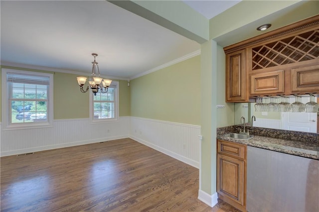 34 Ledgefield Rd, Scituate, RI 02857 - indoor wet bar featuring a wainscoted wall, a chandelier, wood finished floors, crown molding, and decorative light fixtures