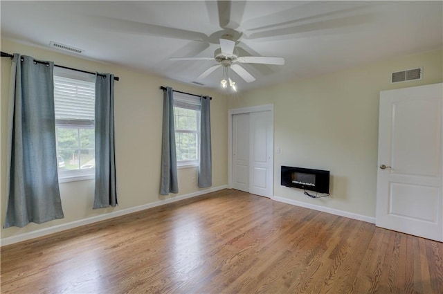 34 Ledgefield Rd, Scituate, RI 02857 - unfurnished living room with a ceiling fan, wood finished floors, and baseboards