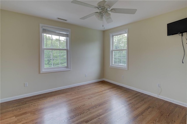 34 Ledgefield Rd, Scituate, RI 02857 - empty room with healthy amount of natural light, wood finished floors, a ceiling fan, and baseboards