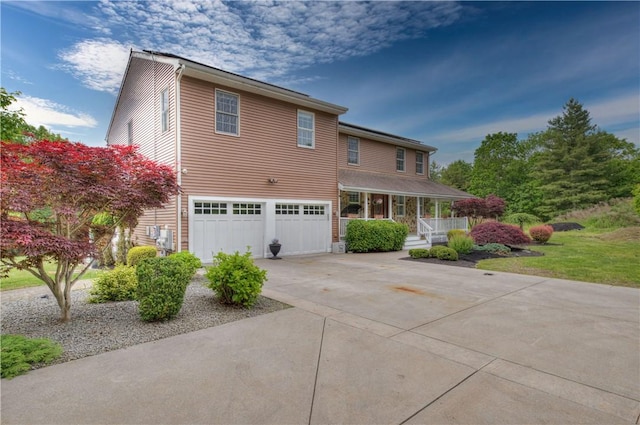 34 Ledgefield Rd, Scituate, RI 02857 - view of front facade featuring a porch, a garage, and concrete driveway