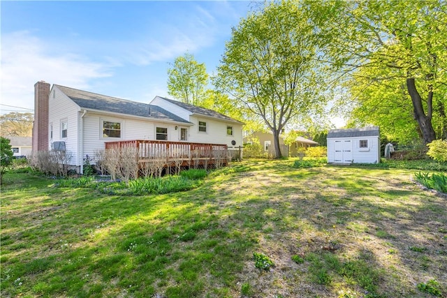54 Glenwood Dr, North Kingstown, RI 02852 - view of grassy yard with a shed, a wooden deck, and an outbuilding