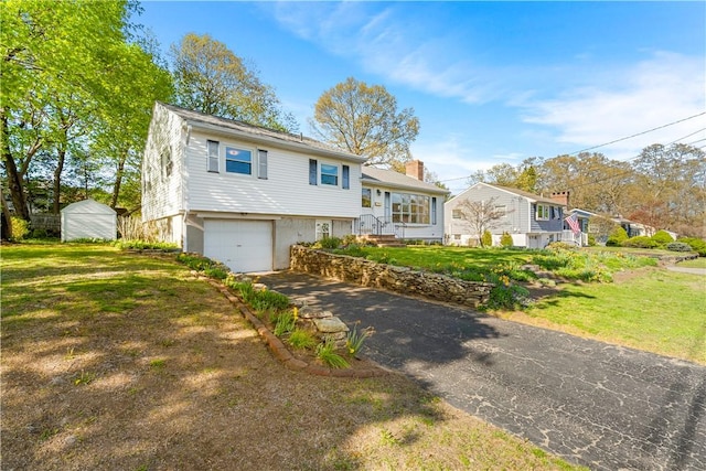 54 Glenwood Dr, North Kingstown, RI 02852 - tri-level home with driveway, a garage, a front lawn, and a shed
