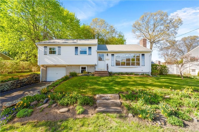 54 Glenwood Dr, North Kingstown, RI 02852 - tri-level home featuring a chimney, a garage, a front yard, and driveway