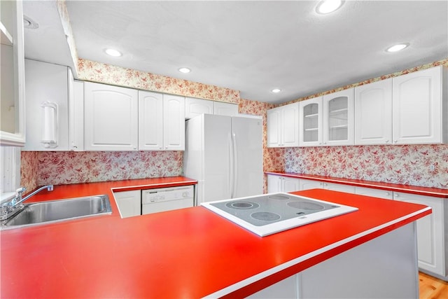54 Glenwood Dr, North Kingstown, RI 02852 - kitchen with white appliances, a sink, wallpapered walls, glass insert cabinets, and white cabinets
