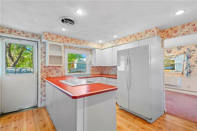 54 Glenwood Dr, North Kingstown, RI 02852 - kitchen with freestanding refrigerator, a peninsula, stovetop, healthy amount of natural light, and wallpapered walls