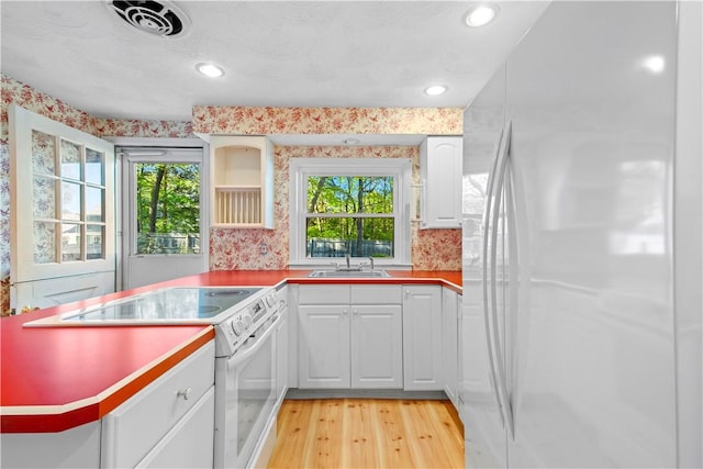 54 Glenwood Dr, North Kingstown, RI 02852 - kitchen with white appliances, light wood-style flooring, a sink, white cabinetry, and open shelves