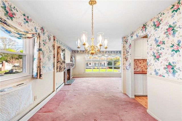 54 Glenwood Dr, North Kingstown, RI 02852 - unfurnished dining area featuring wallpapered walls, a chandelier, wainscoting, plenty of natural light, and light carpet