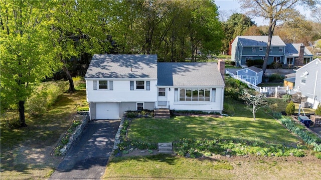 54 Glenwood Dr, North Kingstown, RI 02852 - split level home with asphalt driveway, an attached garage, a residential view, a front yard, and a shingled roof
