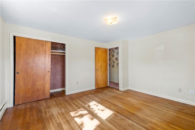 54 Glenwood Dr, North Kingstown, RI 02852 - unfurnished bedroom with hardwood / wood-style floors, baseboards, a closet, and a baseboard heating unit