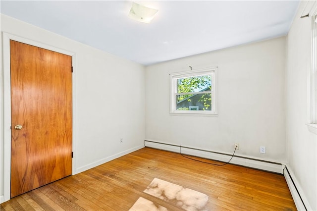 54 Glenwood Dr, North Kingstown, RI 02852 - empty room with a baseboard radiator, hardwood / wood-style flooring, and baseboards