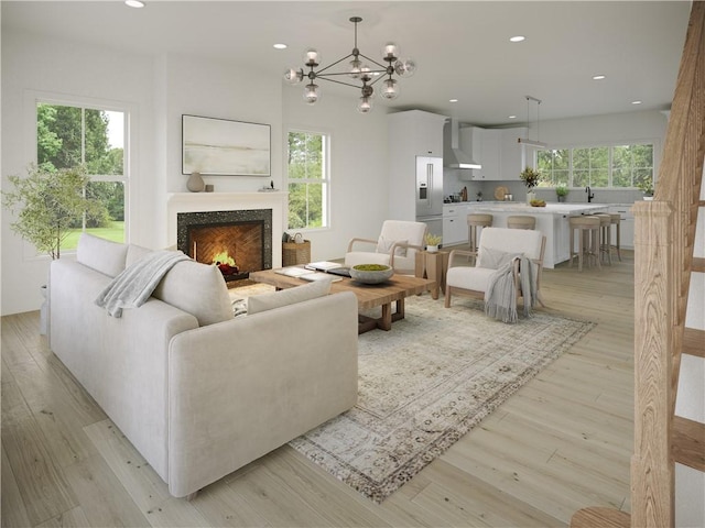 5 Stoneridge Rd, Smithfield, RI 02917 - living room featuring recessed lighting, light wood finished floors, a chandelier, and a warm lit fireplace