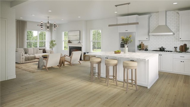 5 Stoneridge Rd, Smithfield, RI 02917 - kitchen with stainless steel refrigerator, wall chimney exhaust hood, light wood-style floors, open floor plan, and recessed lighting