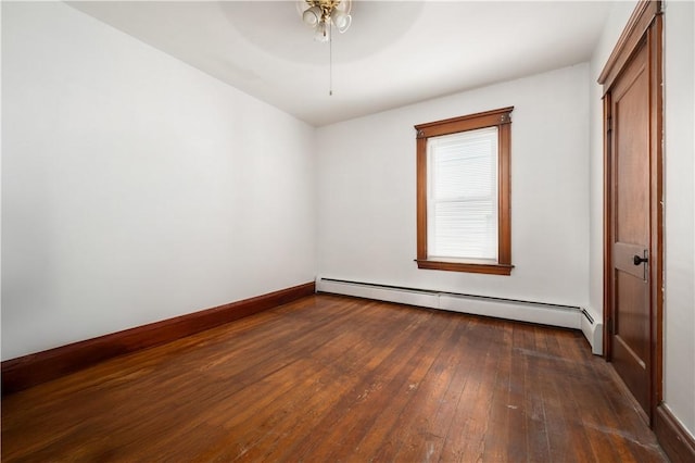 645 Providence St, Woonsocket, RI 02895 - spare room featuring a baseboard radiator, dark wood-style floors, a ceiling fan, and baseboards