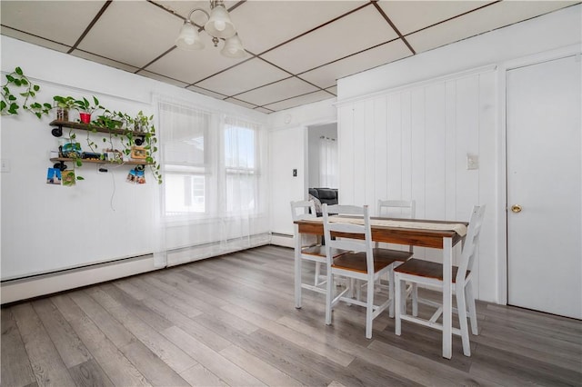 645 Providence St, Woonsocket, RI 02895 - dining space featuring a chandelier, wood finished floors, and baseboard heating