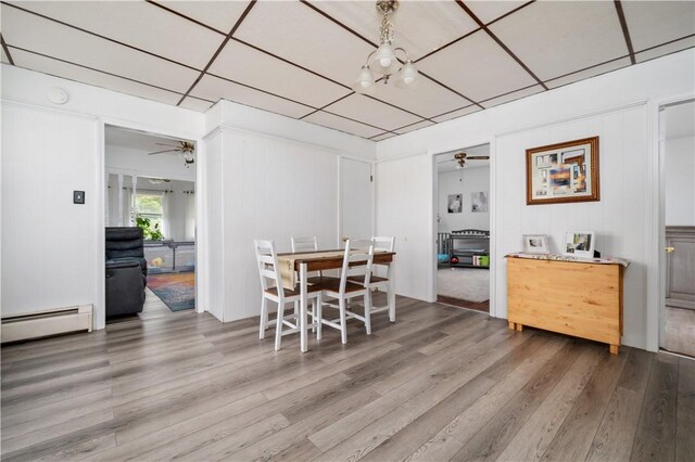 645 Providence St, Woonsocket, RI 02895 - dining space with baseboard heating, a ceiling fan, and wood finished floors