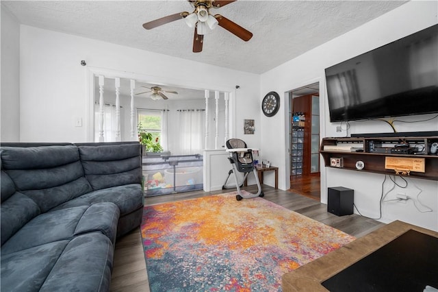 645 Providence St, Woonsocket, RI 02895 - living area featuring a ceiling fan, wood finished floors, and a textured ceiling