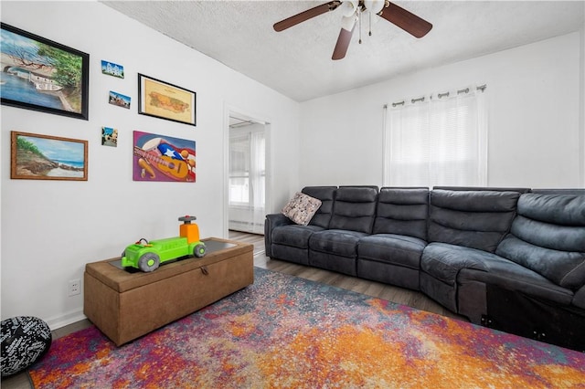 645 Providence St, Woonsocket, RI 02895 - living room featuring wood finished floors, a ceiling fan, baseboards, and a textured ceiling
