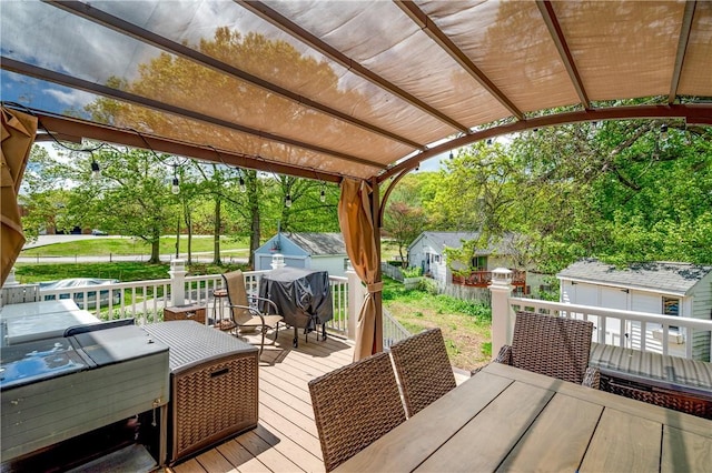 645 Providence St, Woonsocket, RI 02895 - deck featuring an outbuilding, outdoor dining space, a pergola, a storage shed, and view of wooded area
