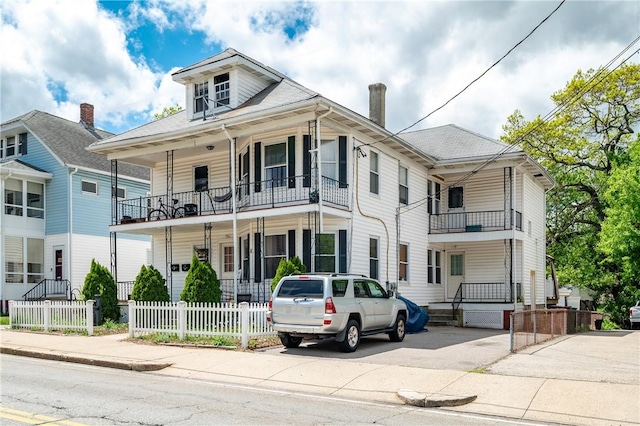645 Providence St, Woonsocket, RI 02895 - view of front of home with fence and a balcony