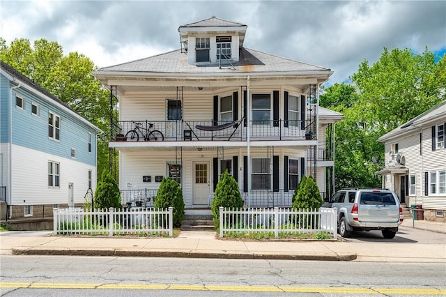 645 Providence St, Woonsocket, RI 02895 - greek revival inspired property featuring a porch, a balcony, and a fenced front yard