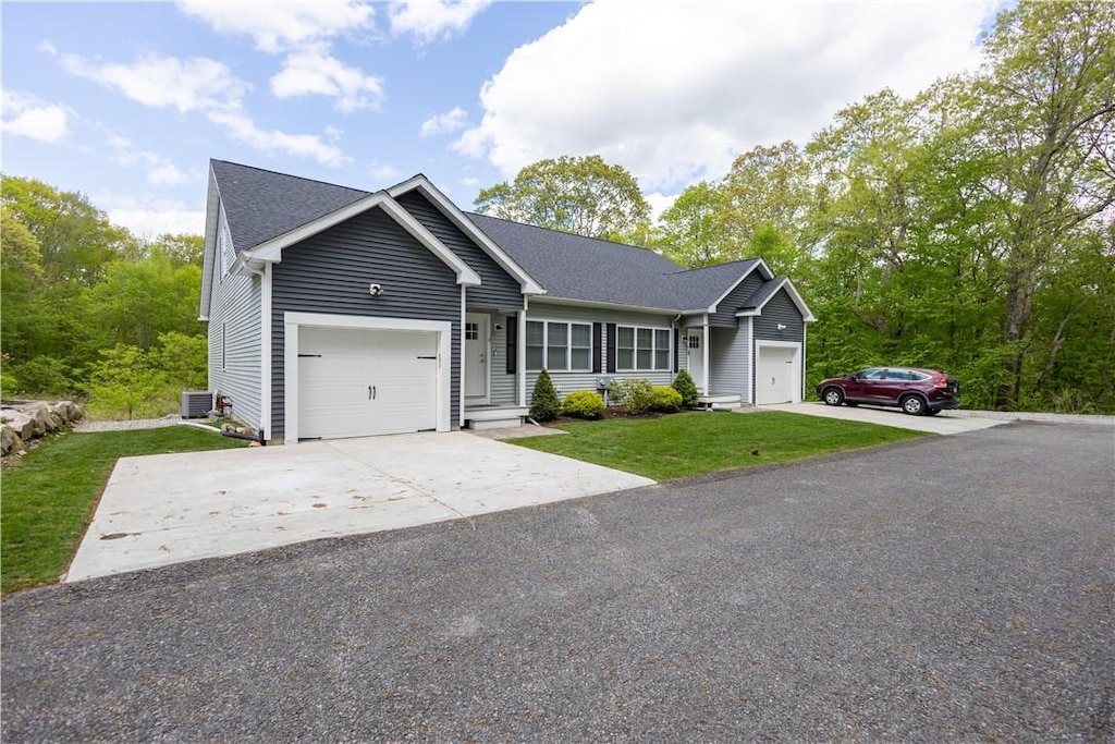 3 Lily Ln, West Warwick, RI 02893 - single story home featuring an attached garage, a front yard, concrete driveway, and central air condition unit