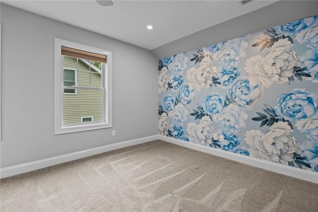 carpeted empty room featuring baseboards and recessed lighting