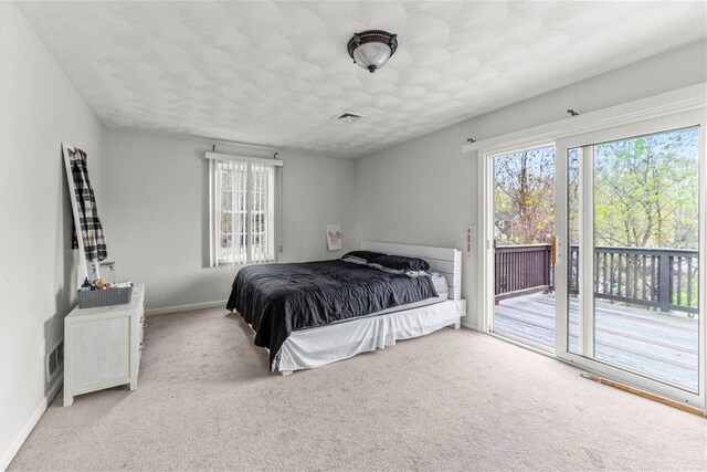 bedroom featuring access to outside, baseboards, and carpet floors