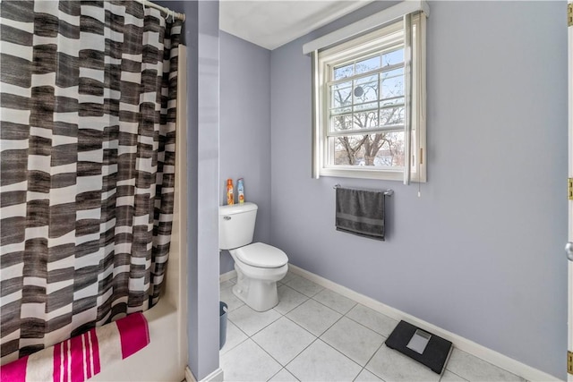 full bath featuring baseboards, toilet, and tile patterned flooring