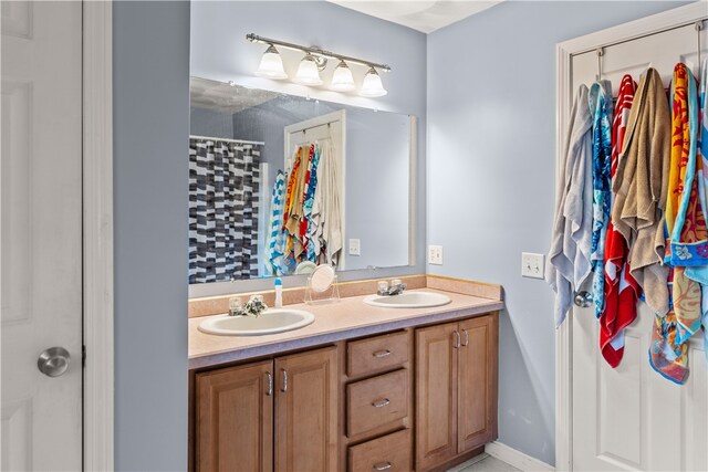 bathroom with double vanity and a shower with curtain