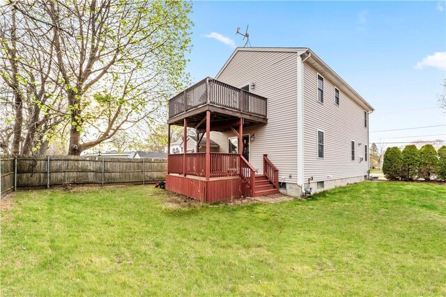 rear view of property featuring a deck and crawl space