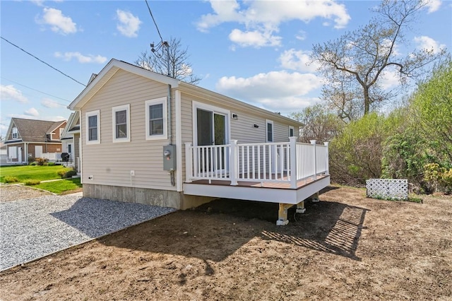 back of property featuring a wooden deck