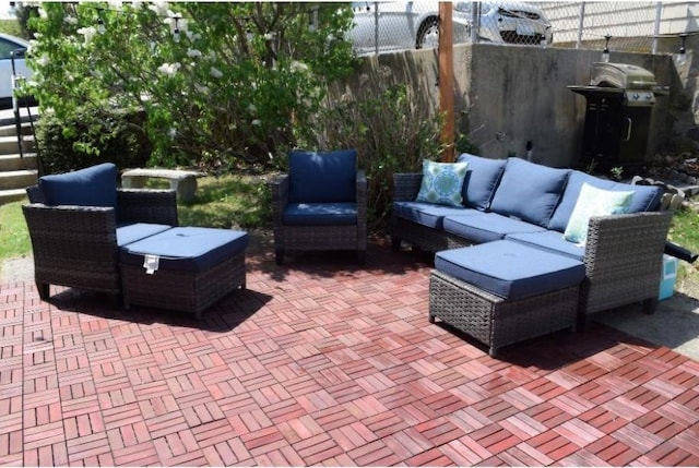 view of patio / terrace with outdoor lounge area, fence, and grilling area