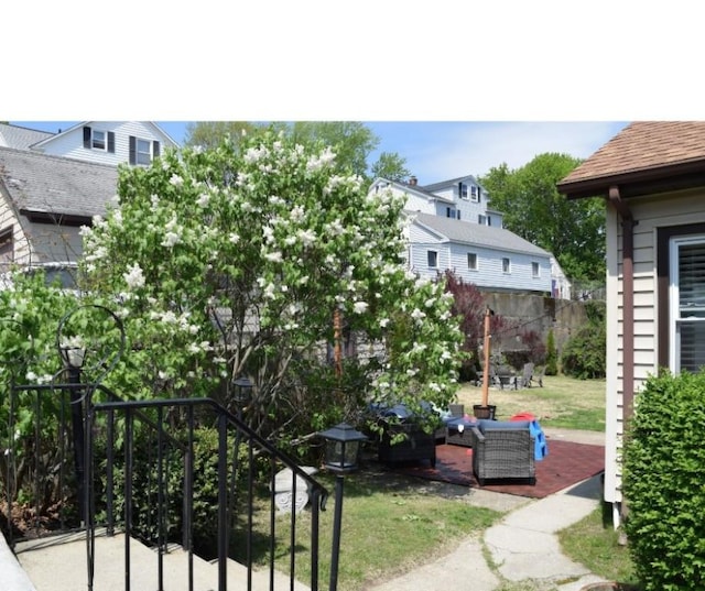 view of green lawn featuring a patio and an outdoor living space