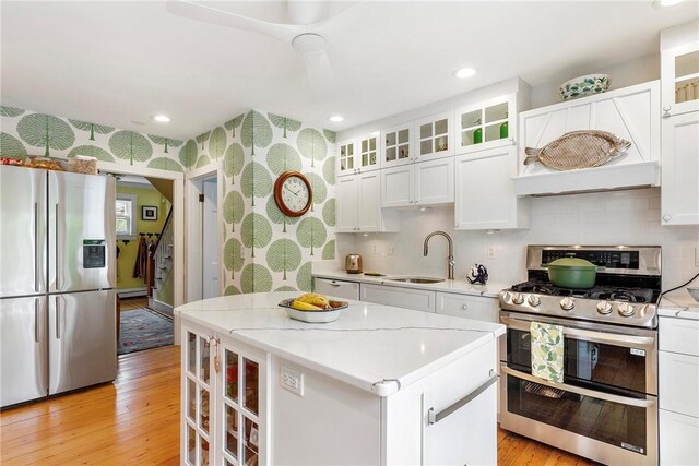 15 Cross St, Newport, RI 02840 - kitchen featuring stainless steel appliances, a sink, a kitchen island, light wood-type flooring, and recessed lighting