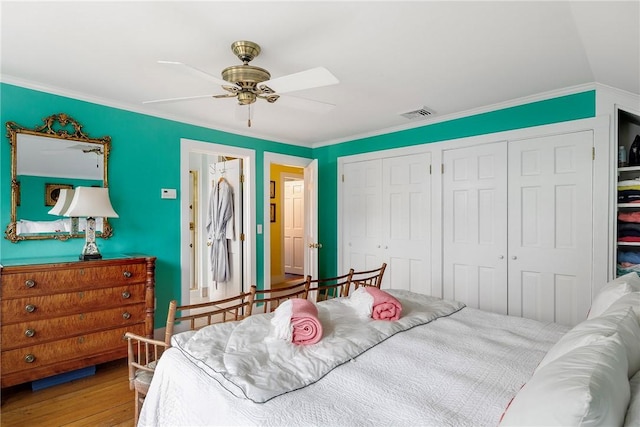 15 Cross St, Newport, RI 02840 - bedroom with multiple closets, crown molding, wood finished floors, and a ceiling fan