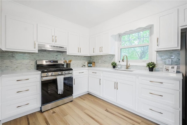 7 Maggio Ave, Westerly, RI 02891 - kitchen featuring under cabinet range hood, stainless steel gas range oven, a sink, light countertops, and white cabinetry