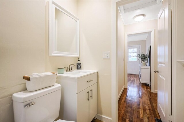 7 Maggio Ave, Westerly, RI 02891 - half bathroom featuring wood finished floors, vanity, toilet, baseboards, and ornamental molding