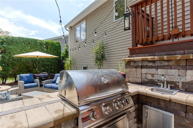 view of patio / terrace with a grill, a sink, and exterior kitchen