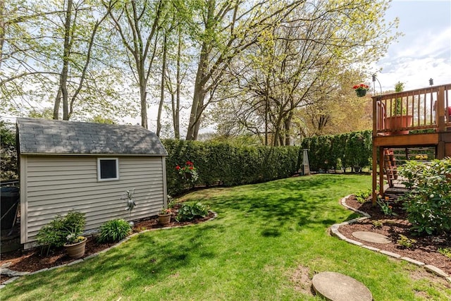 view of yard with an outbuilding, a deck, and a storage shed